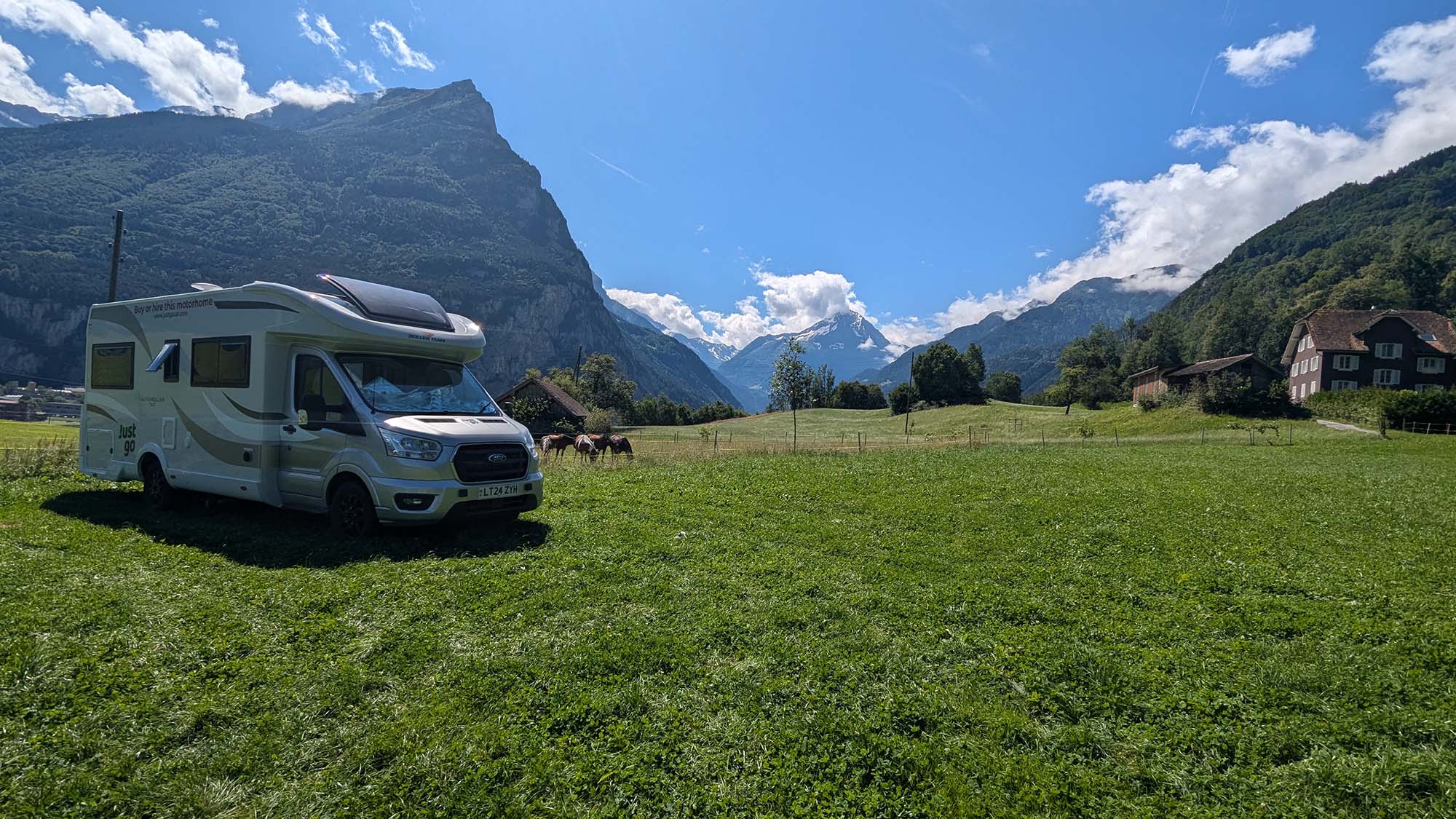 A hired motorhome parked in a mountain valley on a mainland Europe road trip